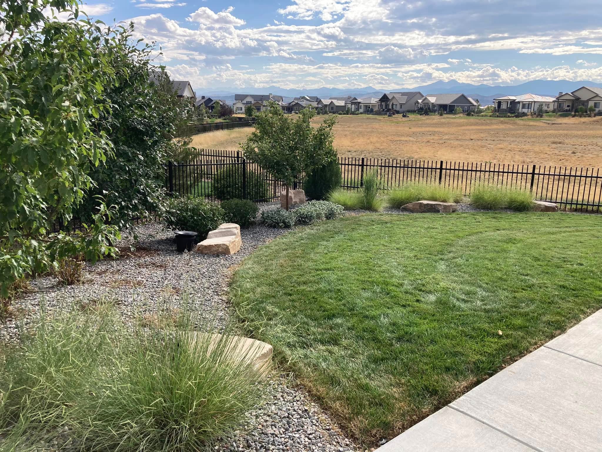 Backyard with mowed lawn and distant mountain views