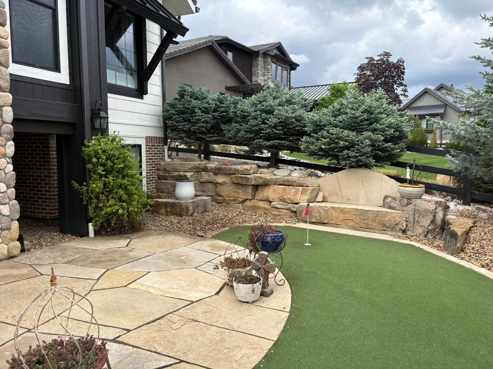 Backyard with artificial turf and terraced retaining wall