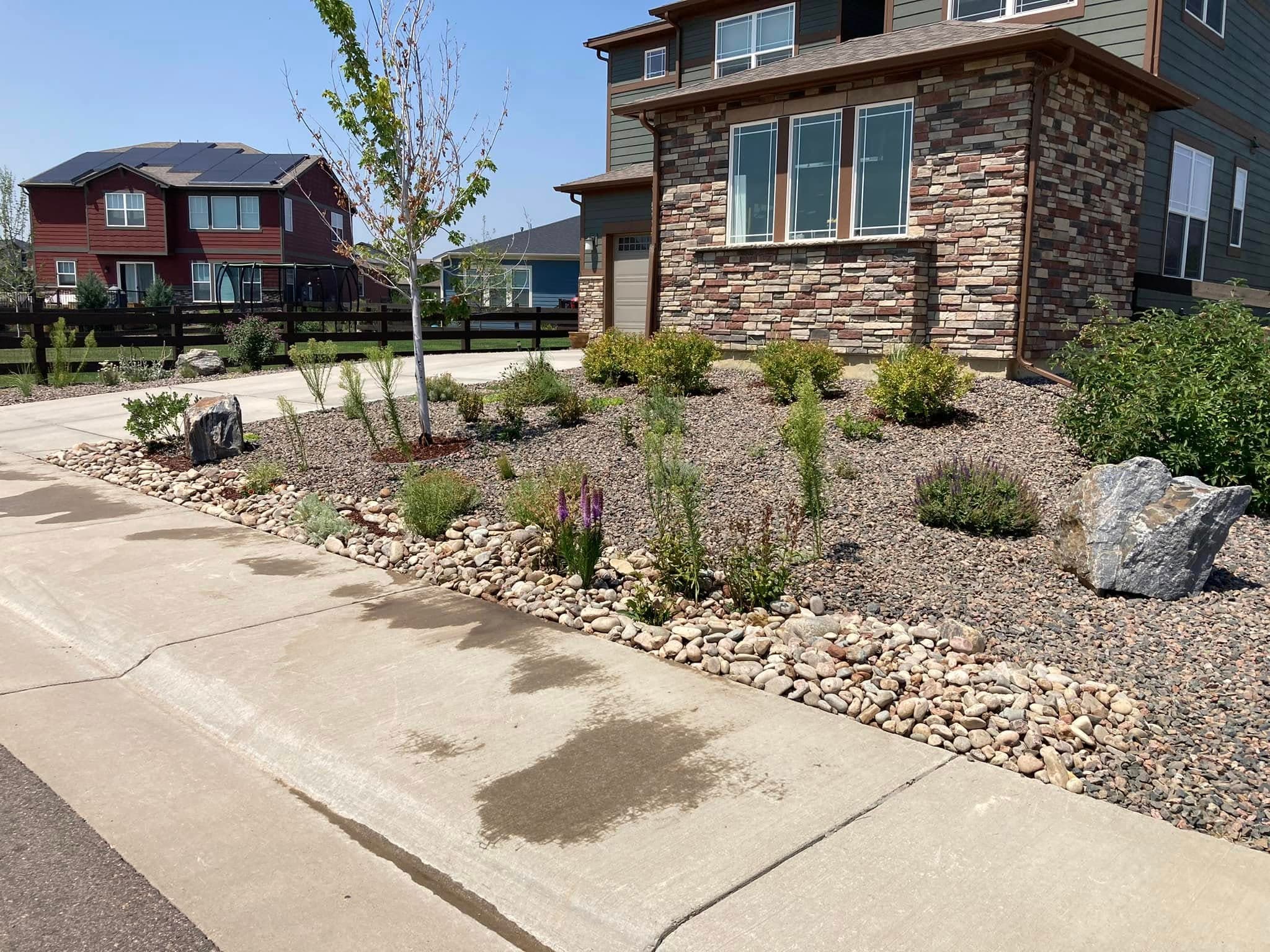 Front facade with xeriscaped beds and decorative stone