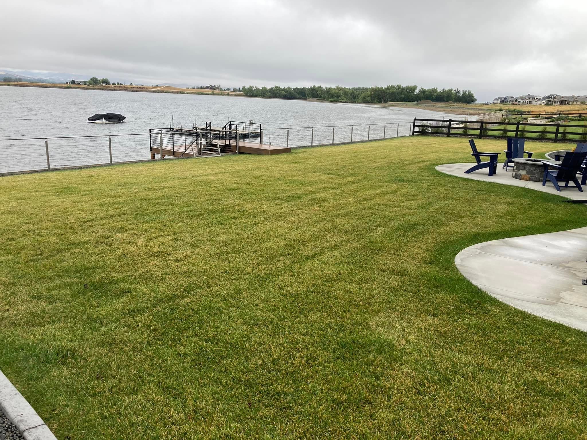 Waterfront landscape with manicured lawn and dock