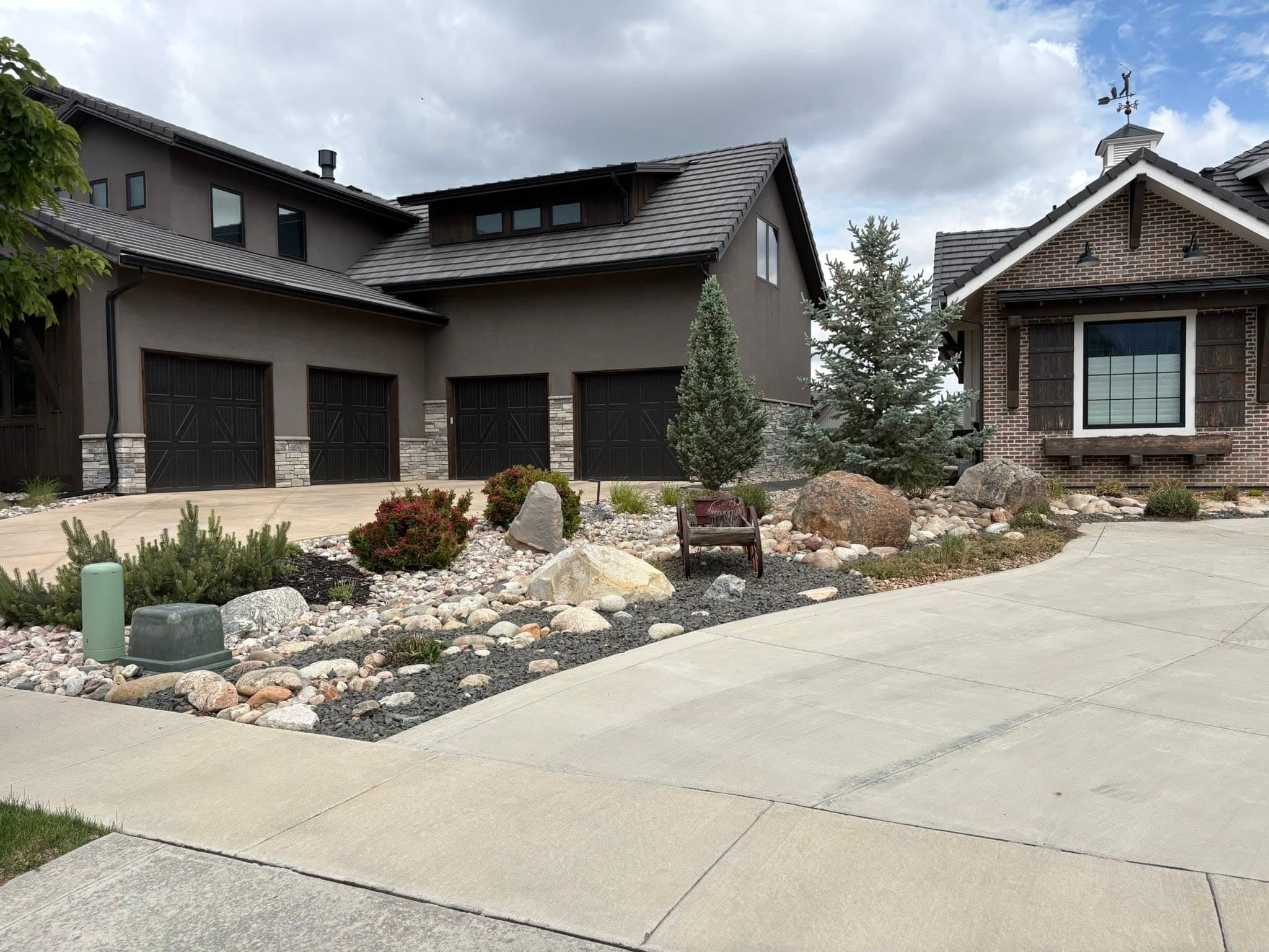 Modern home with tiered retaining walls and river rock