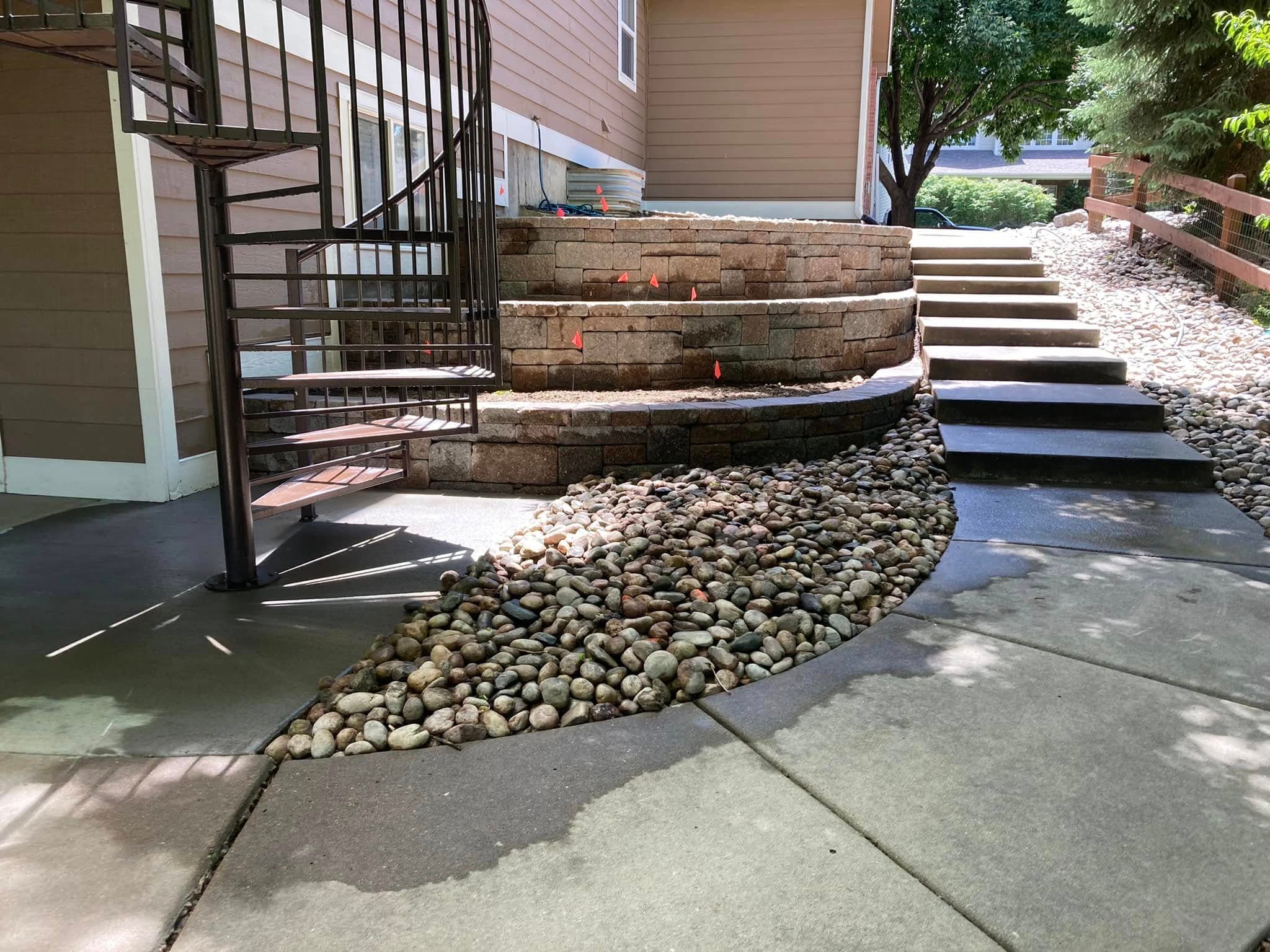 Curved gravel pathway with wooden planter box and steps